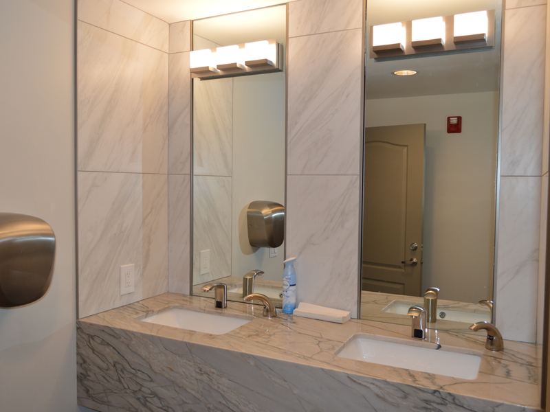 Fitness center bathroom with marble-look counters