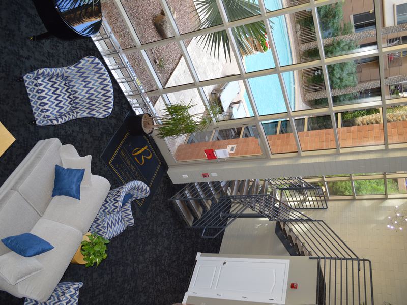Two-story clubhouse lounge with a staircase and a view of the pool